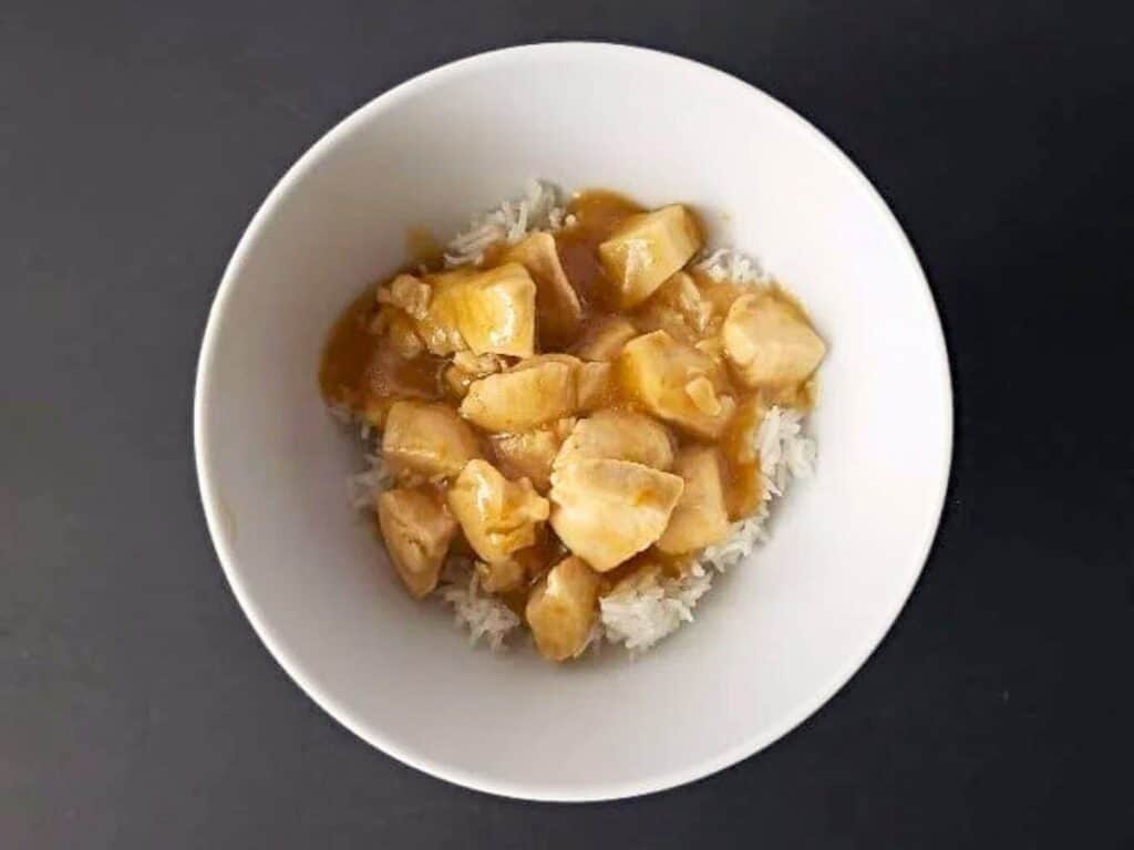 Image shows bowl of yummy homemade orange chicken.