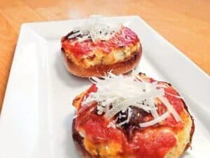Image shows plate of tasty mini lasagna pizzas.