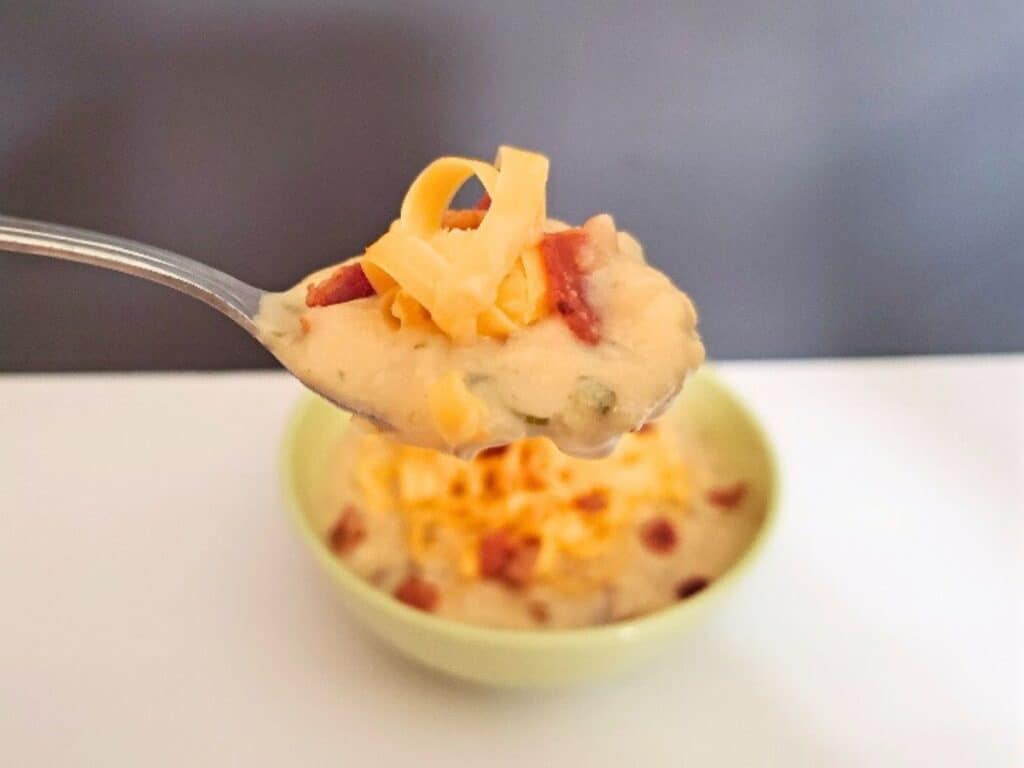 Image shows spoonful of delicious instant pot baked potato soup.