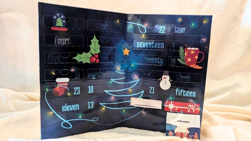 An open Advent calendar with numbered doors, Christmas-themed illustrations, and one slot revealing a packet labeled "white angels"—perfect for those who cherish unique Advent calendars.