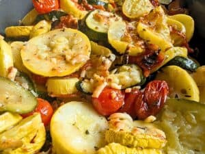 Sliced yellow squash, zucchini, and cherry tomatoes roasted with herbs and melted cheese.