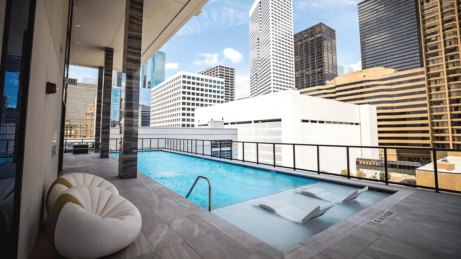 Luxury rooftop swimming pool with city skyline views in Houston, ideal for EB5 investment opportunities involving upscale properties and real estate development.