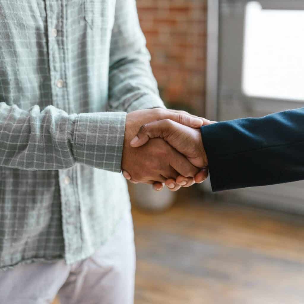 Handshake agreement between two business professionals for Houston EB5 investment opportunities.