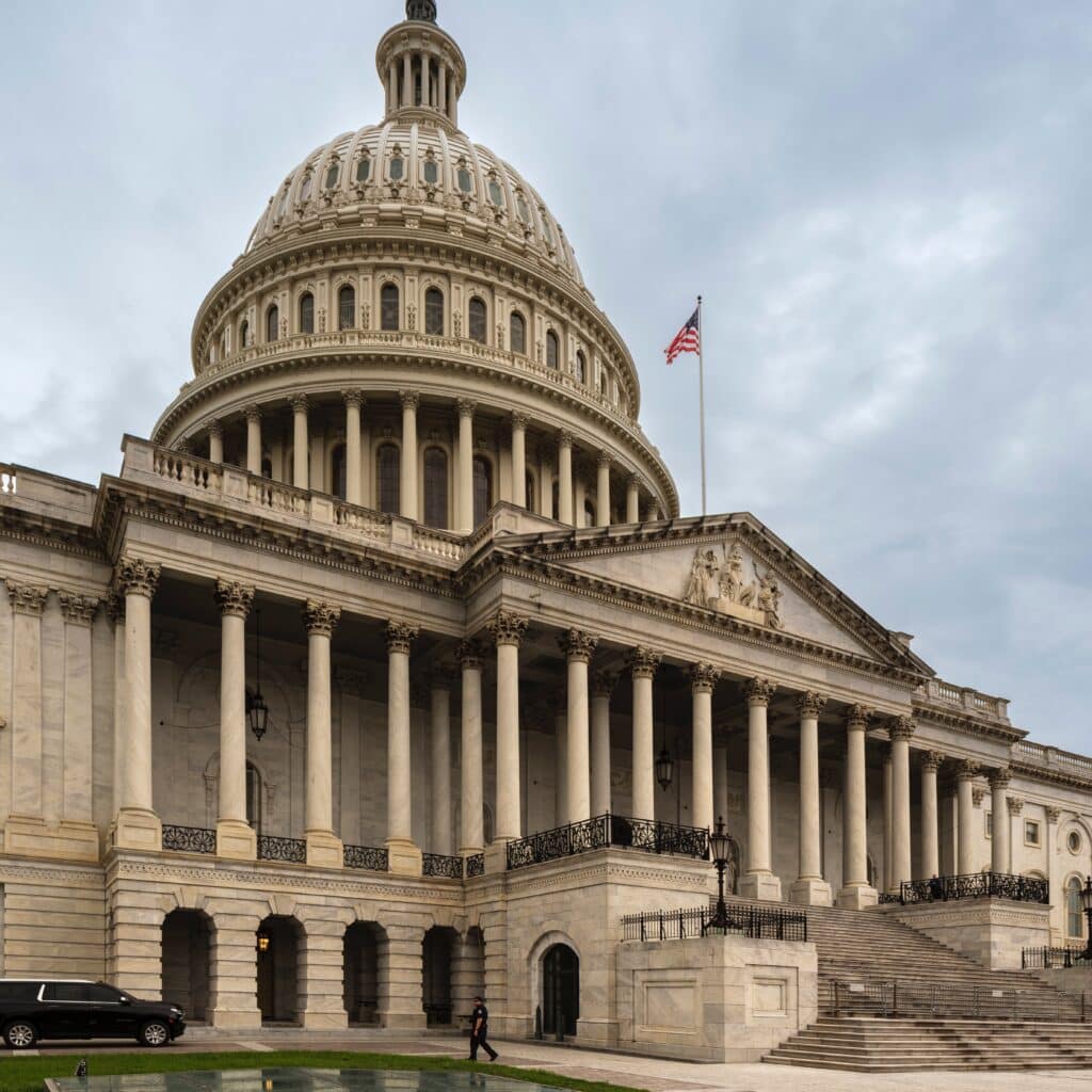 High-resolution image of the U.S. Capitol building in Washington, D.C., showcasing iconic architecture and the American flag. Perfect for content on U.S. government, politics, and legal investment opportunities.