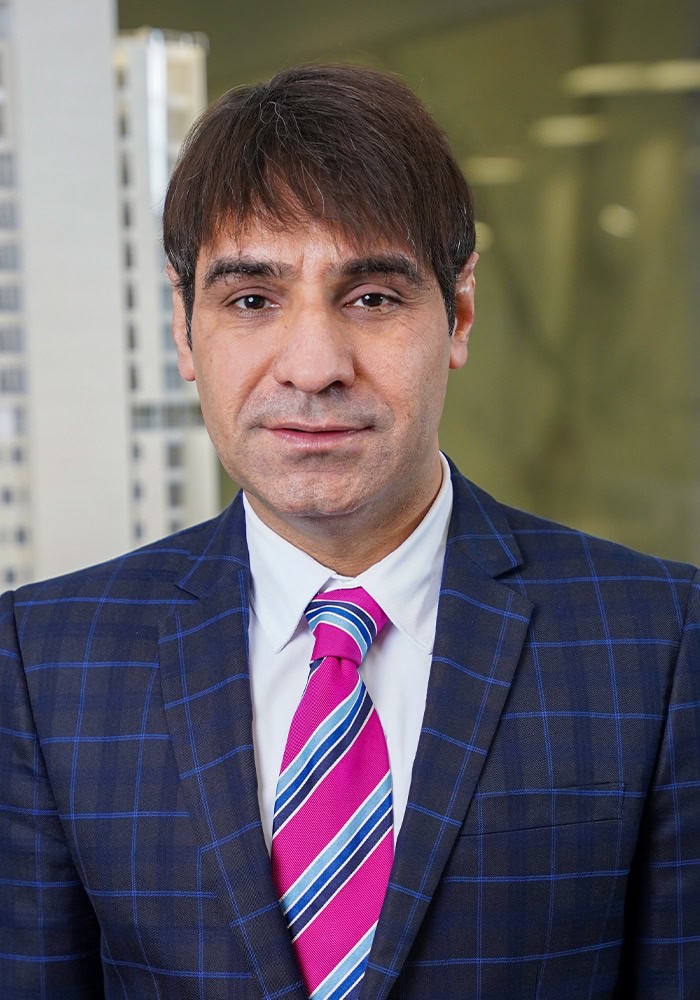 Professional businessman in a suit representing Houston EB5 investment opportunities in Houston real estate.