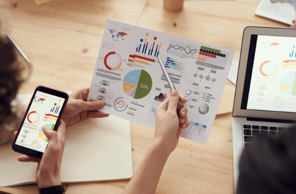 High-quality business presentation with charts and graphs on digital devices, demonstrating investment opportunities in Houston EB5 immigration programs for clients and investors.