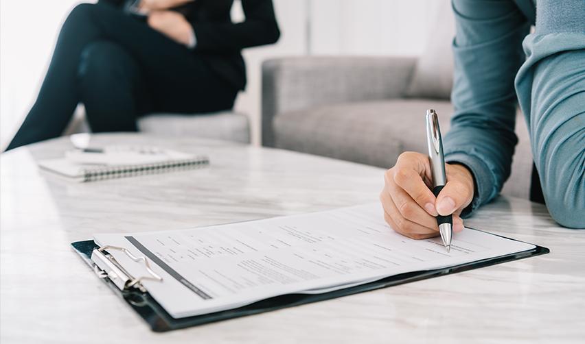 Business signing legal documents for Houston EB5 investment opportunities, highlighting immigration and visa process.