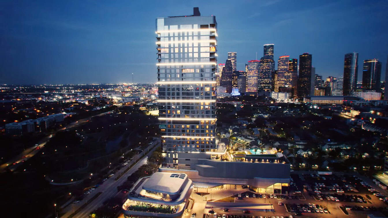 Luxury Houston skyscraper illuminated at night, showcasing modern architecture and vibrant city skyline, perfect for EB-5 investment opportunities in Houston.