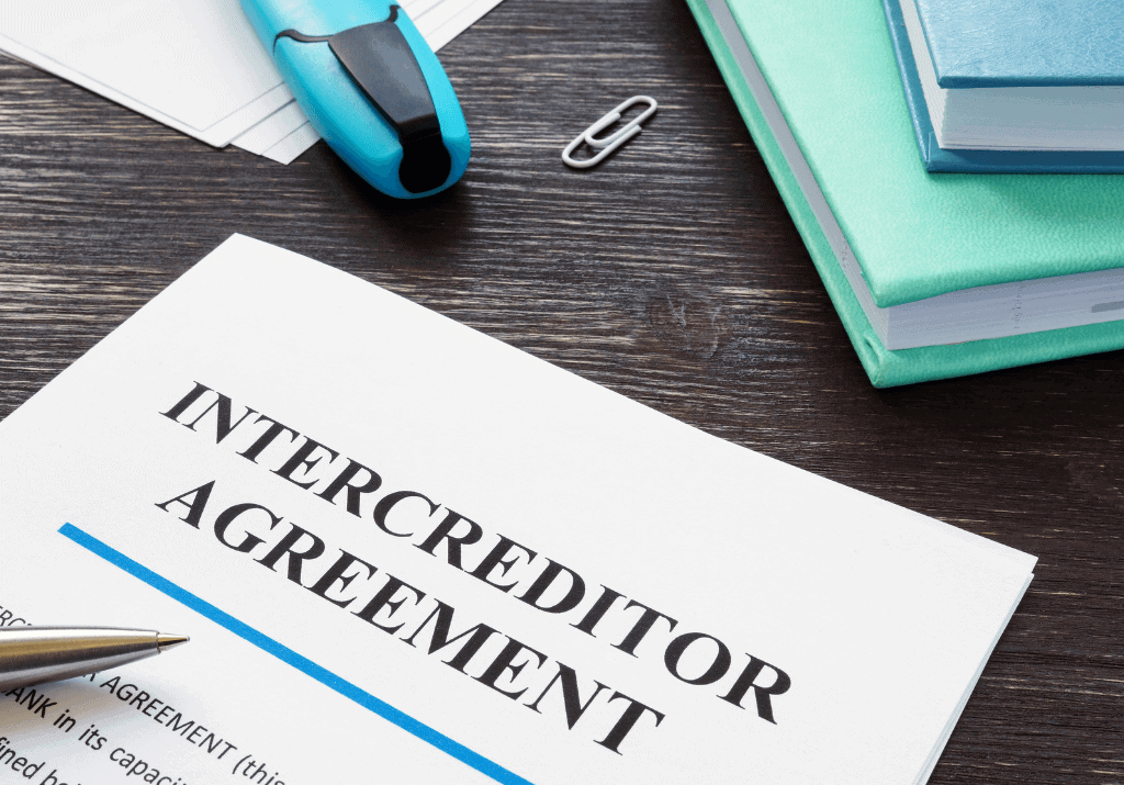 Intercreditor agreement document on a wooden desk with office supplies, representing legal and investment processes for Houston EB5 investment opportunities.