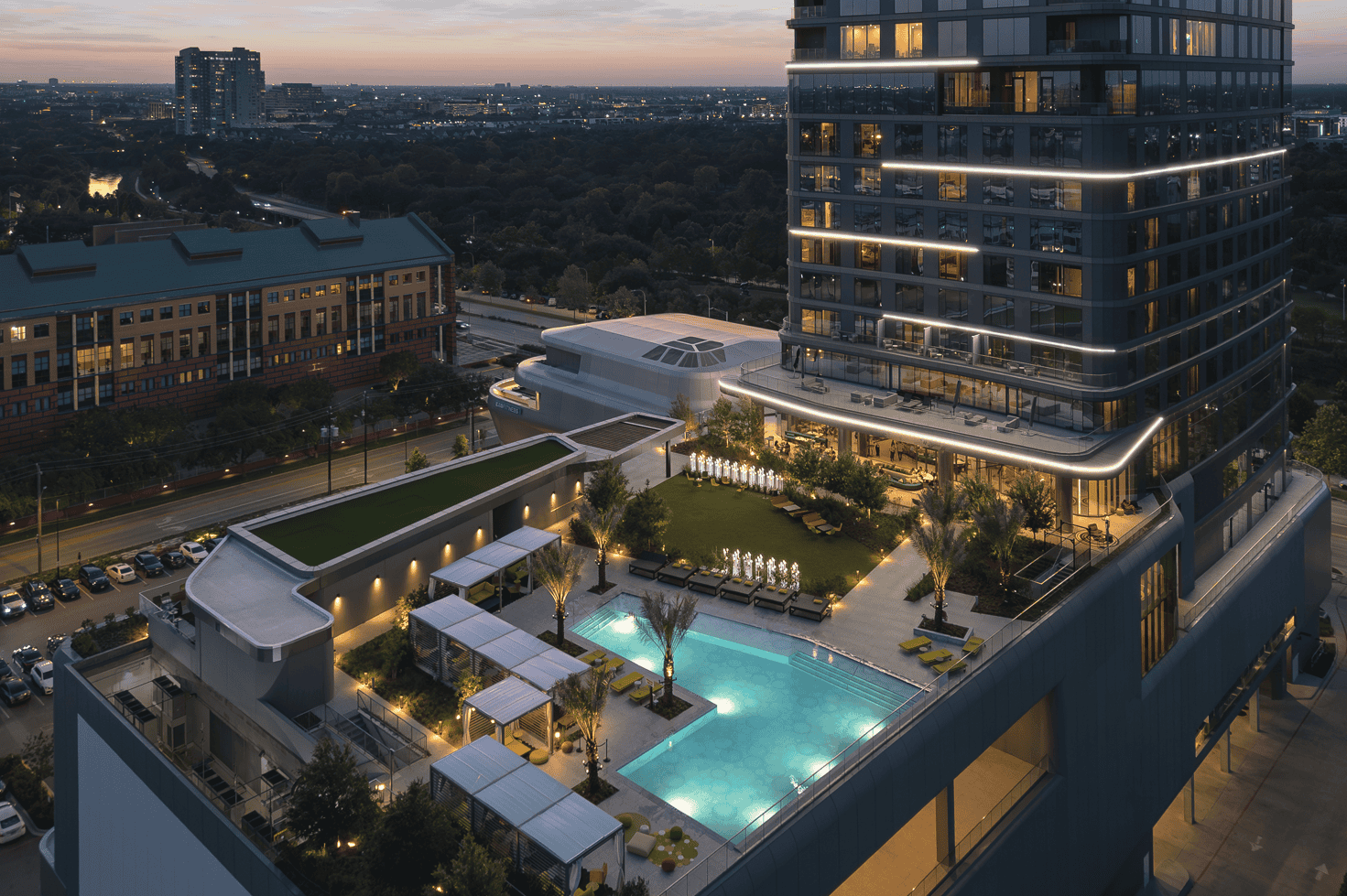 Luxury downtown Houston residential building with rooftop pool, modern amenities, and city skyline at dusk.