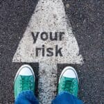 Risk of financial loss warning on street pavement emphasizing cautious investment in Houston EB5 programs.