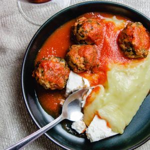 Turkey and spinach meatballs in tomato sauce with mashed potatoes and feta cheese