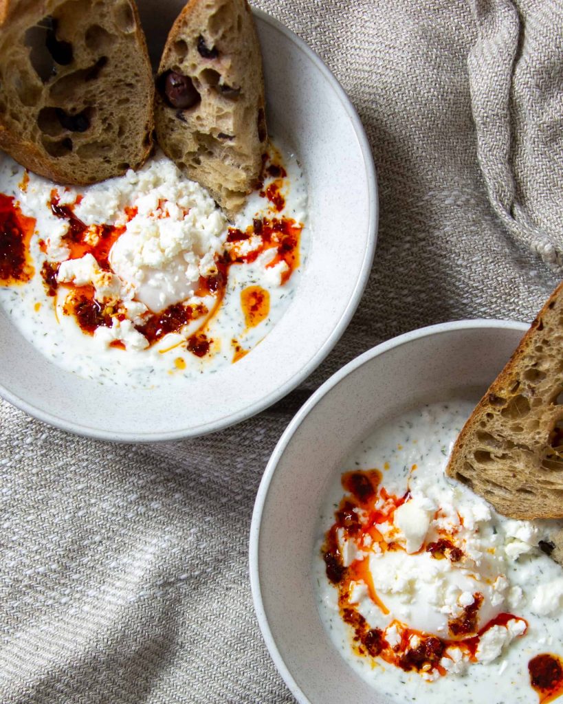 two bowls of eggs panagyrski with bread.