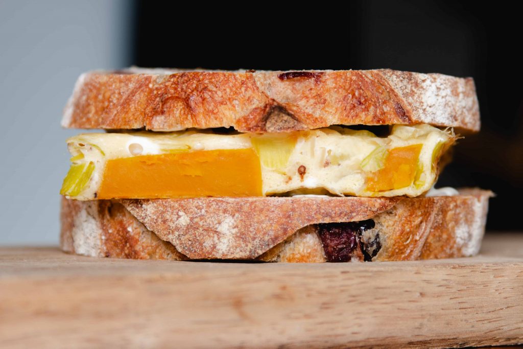 baked omelette sandwich on rustic olive bread