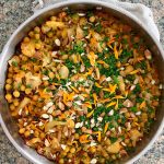 a pan of baked orzo with herbs on top.