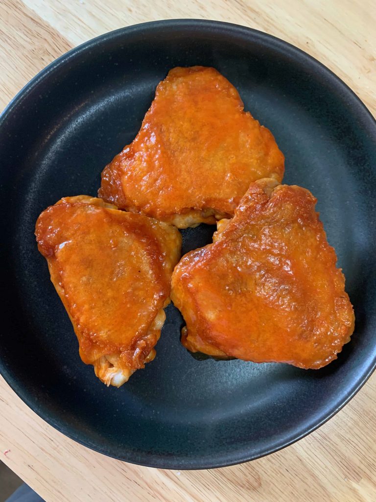 a plate of buffalo chicken thighs.