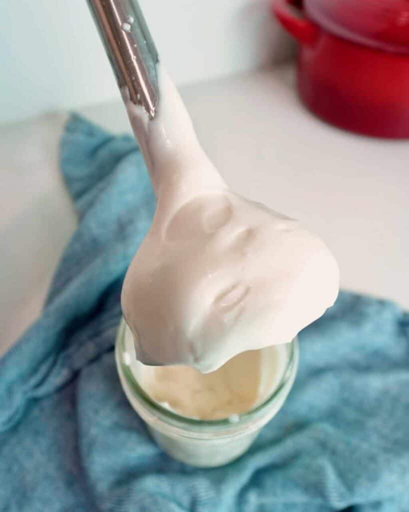 An immersion blender after blending mayonnaise.