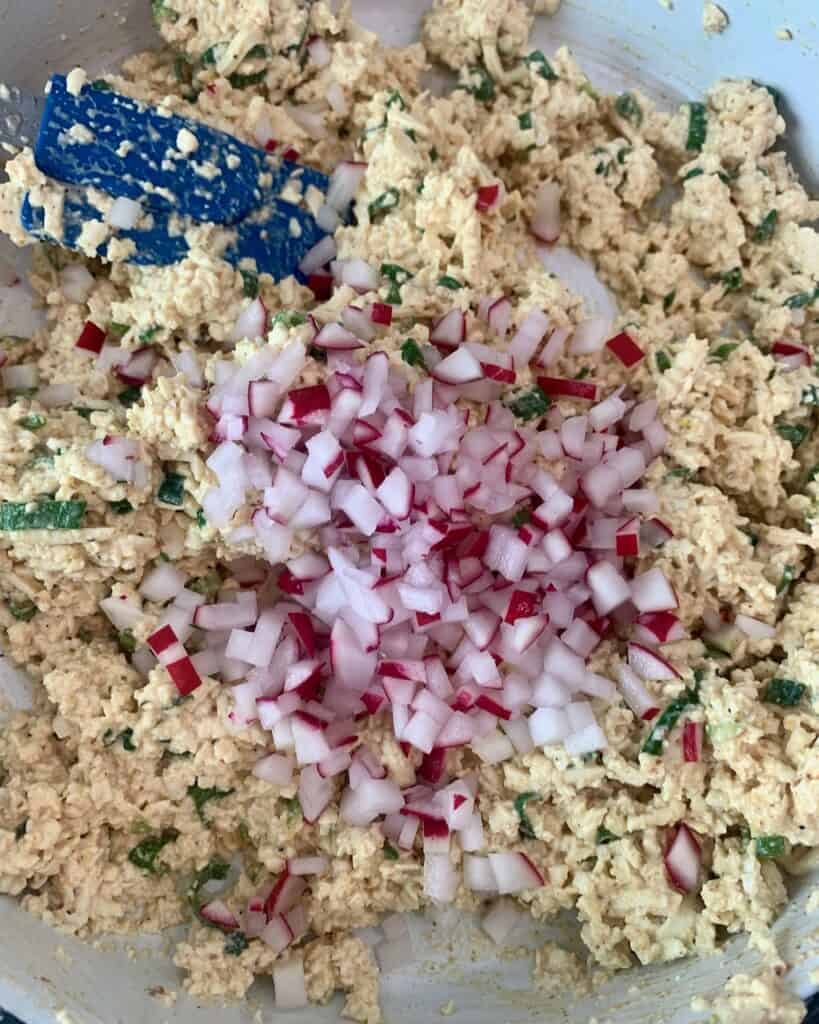 Tofu salad with finely chopped radishes ready to be stirred in.