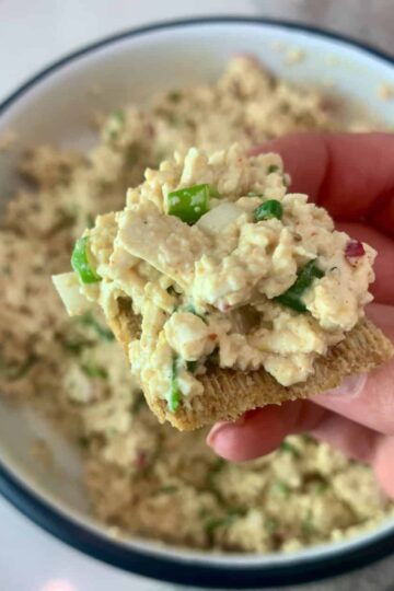 Tofu salad piled on top of a Triscuit cracker.