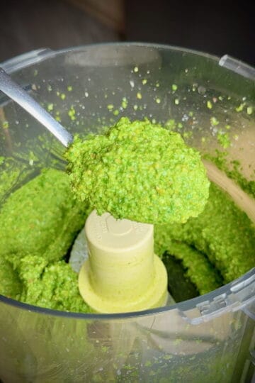 A spoonful of vibrant radish greens pesto straight from the food processor.