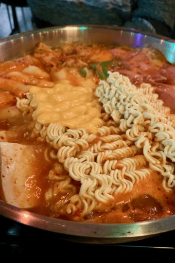 A large pot of army stew cooking.