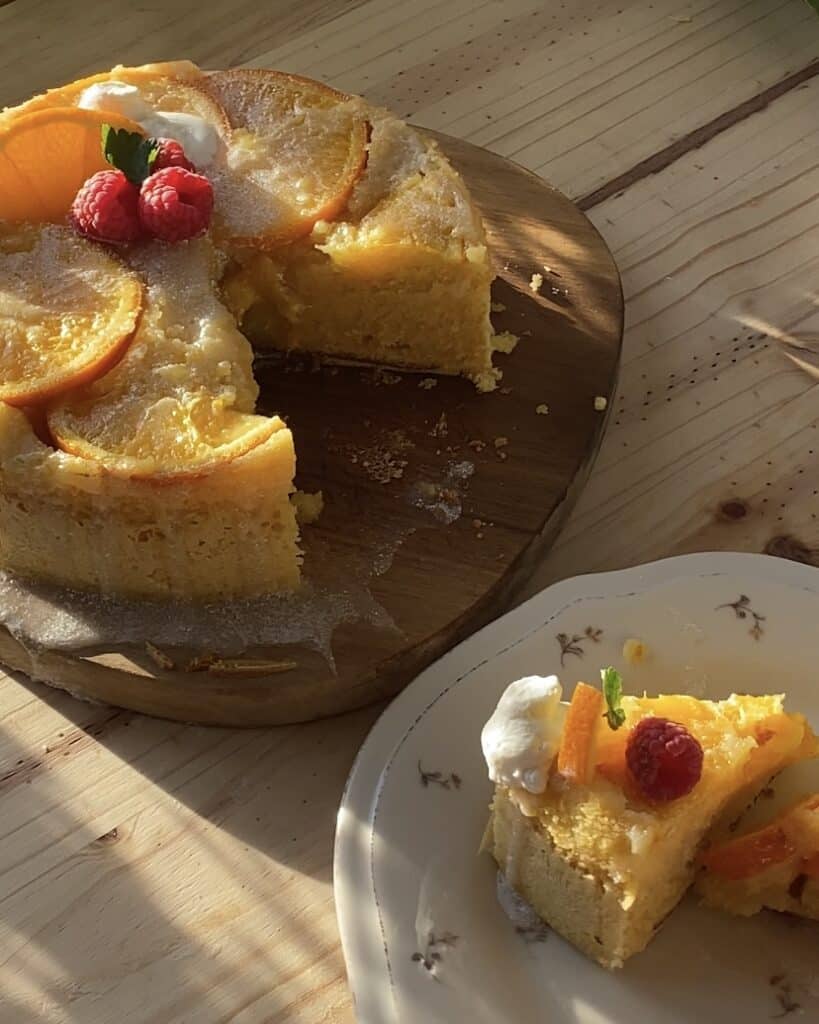 Moist upside-down orange cake with a separate slice showcasing vibrant orange slices and a soft, fluffy texture, perfect for citrus lovers and dessert enthusiasts