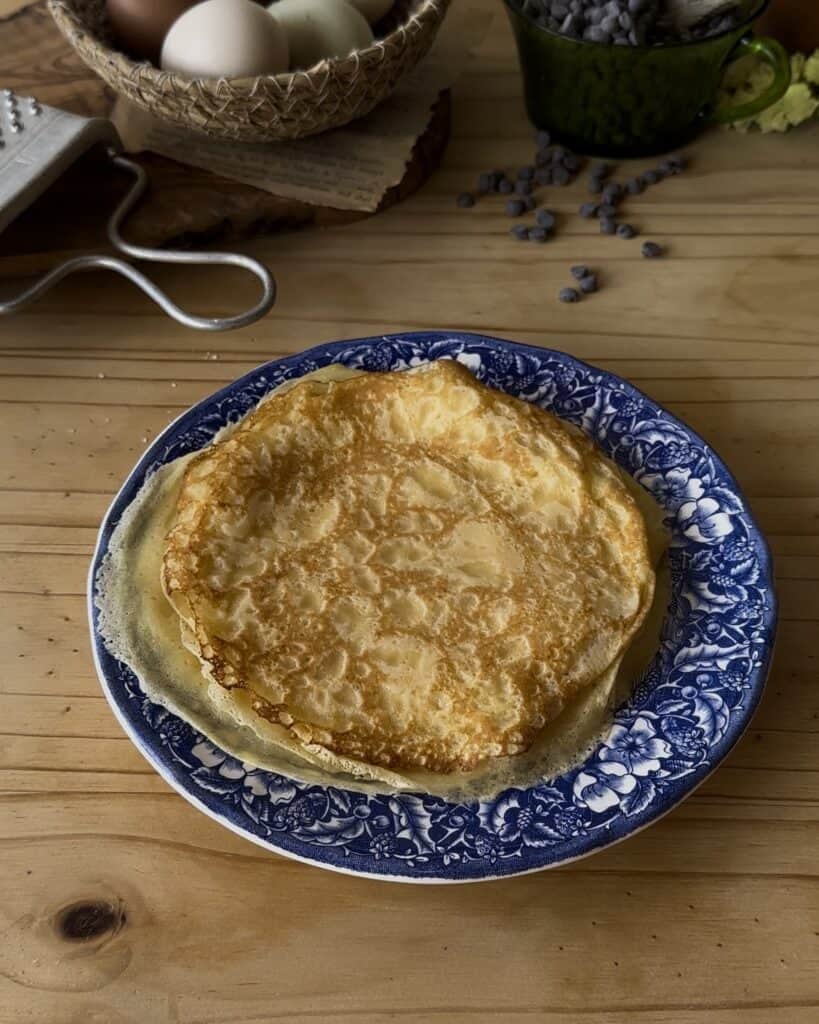 Freshly cooked crepes, golden and tender, ready to be filled and rolled into delicious chocolate crepe rolls