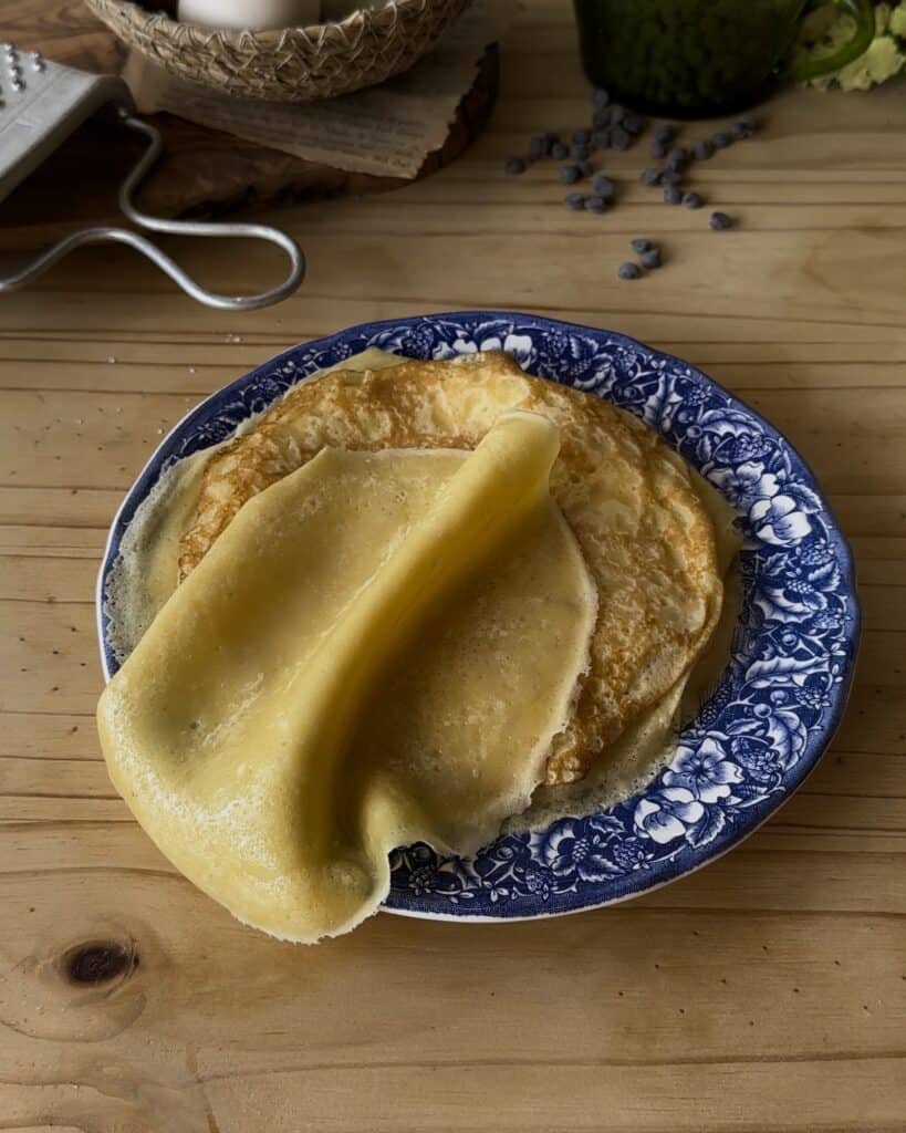 Freshly cooked crepes, golden and tender, ready to be filled and rolled into delicious chocolate crepe rolls