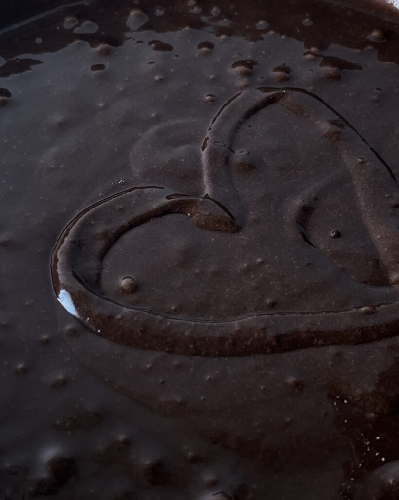 Chocolate cake batter poured into a prepared pan, ready to be baked into a rich and moist cake