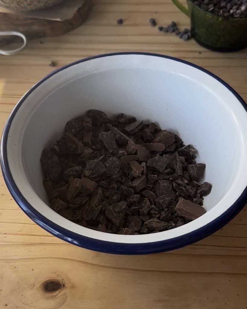 Chopping the chocolate into small pieces to prepare for making a smooth, rich ganache for the chocolate cake