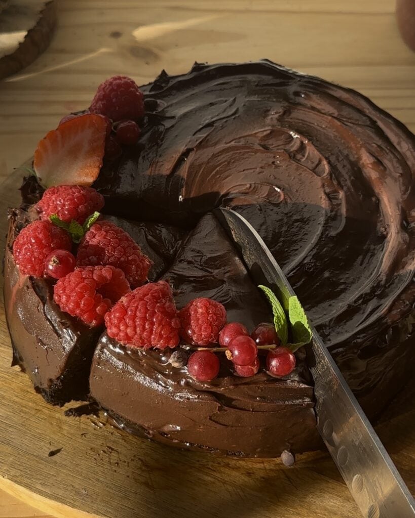 Cutting a portion of chocolate cake, showcasing its rich texture and decadent layers