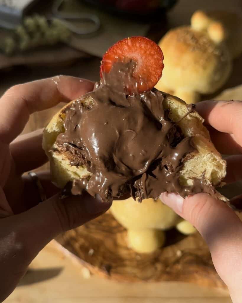 Freshly baked bunny bread with chocolate, cut in half to reveal its soft interior and rich chocolate filling