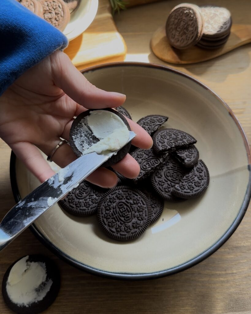 Separating Oreo cookies from their cream filling, preparing the biscuits for the crust and the filling for the no-bake Oreo cheesecake