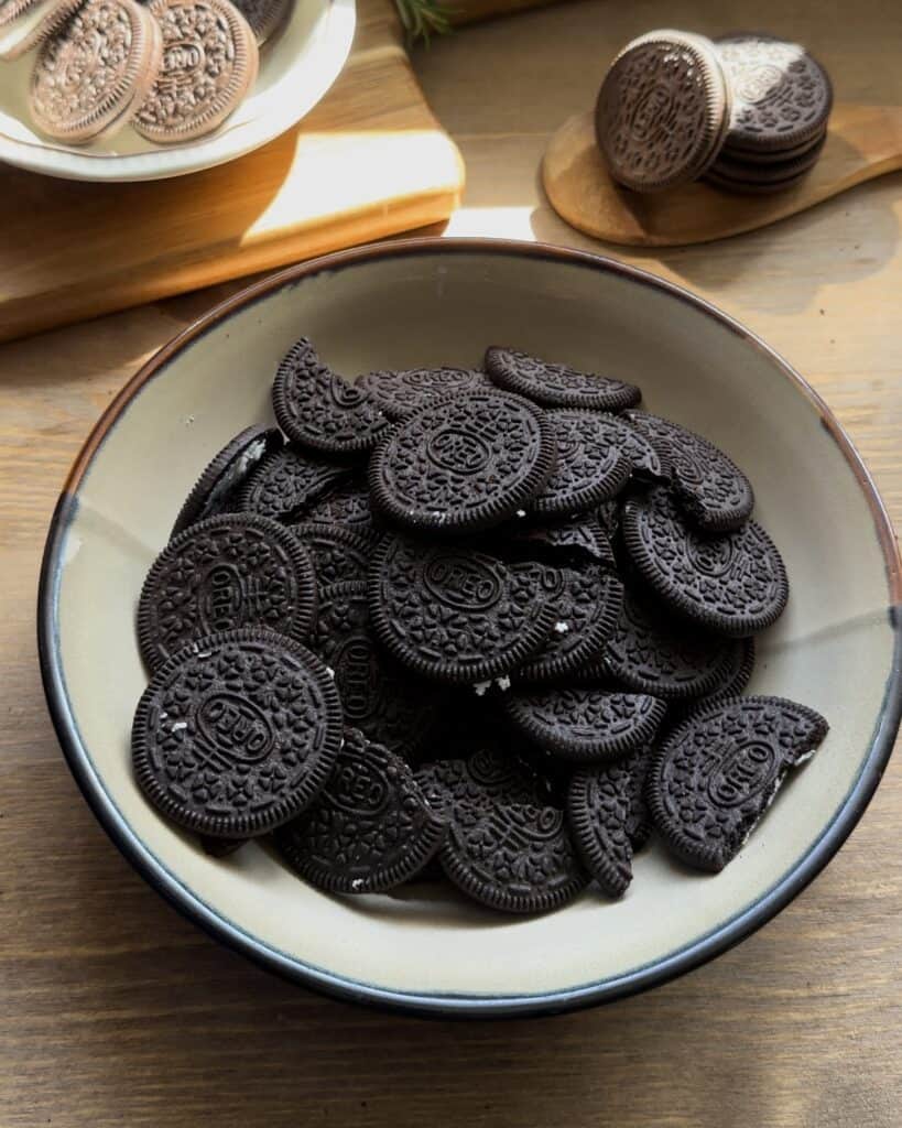 Separating Oreo cookies from their cream filling, preparing the biscuits for the crust and the filling for the no-bake Oreo cheesecake