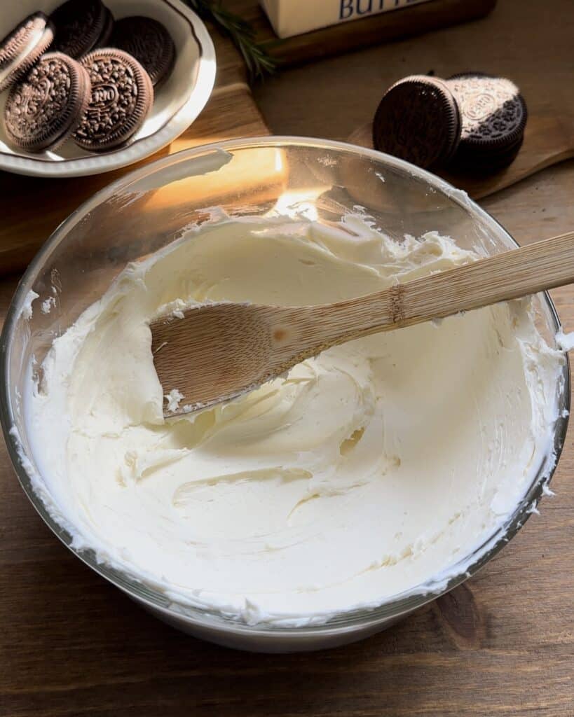 Soften cream cheese to a smooth, spreadable consistency, preparing it for the filling of the no-bake Oreo cheesecake