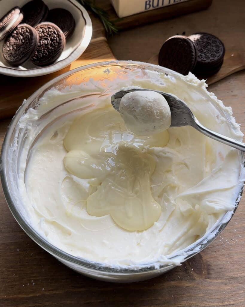 Mixing the Oreo cream filling into the cream cheese, blending it smoothly to enhance the flavor for the no-bake Oreo cheesecake
