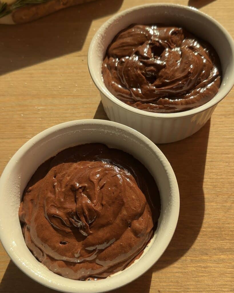Creamy and rich chocolate brownie batter in a baking dish before adding toppings and baking. A delicious and fudgy base for Christmas brownies, perfect for the holiday season.