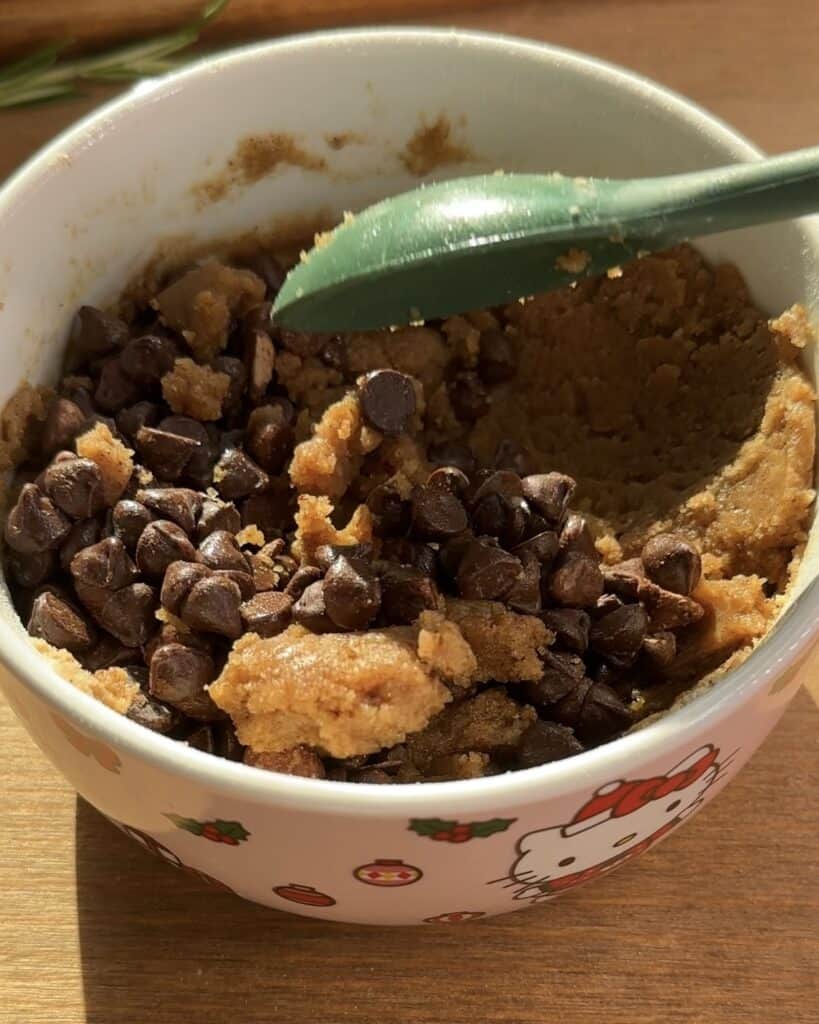 Mixing all-purpose flour, chocolate, milk, and dry milk powder to prepare the cookie dough for a delicious Cookie dough muffins
