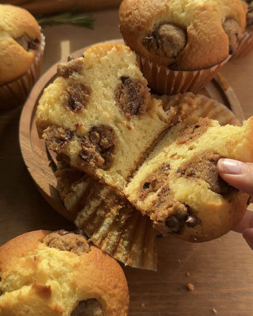 Cookie dough muffin with chocolate, cut open to reveal a gooey center filled with melted chocolate chunks