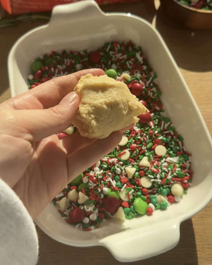 Adding colorful festive confetti sprinkles to the batter for the Festive Holiday Cookies