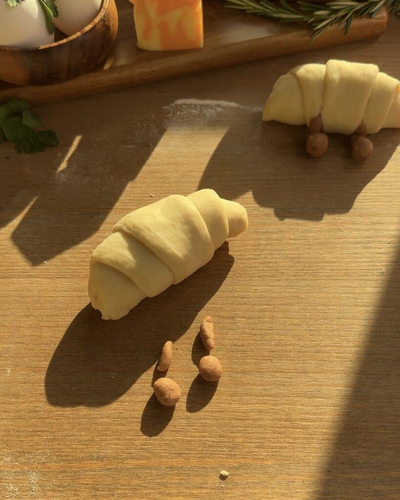 Jellycat croissant filled generously with creamy cheese, perfectly prepared and ready to be baked to golden perfection