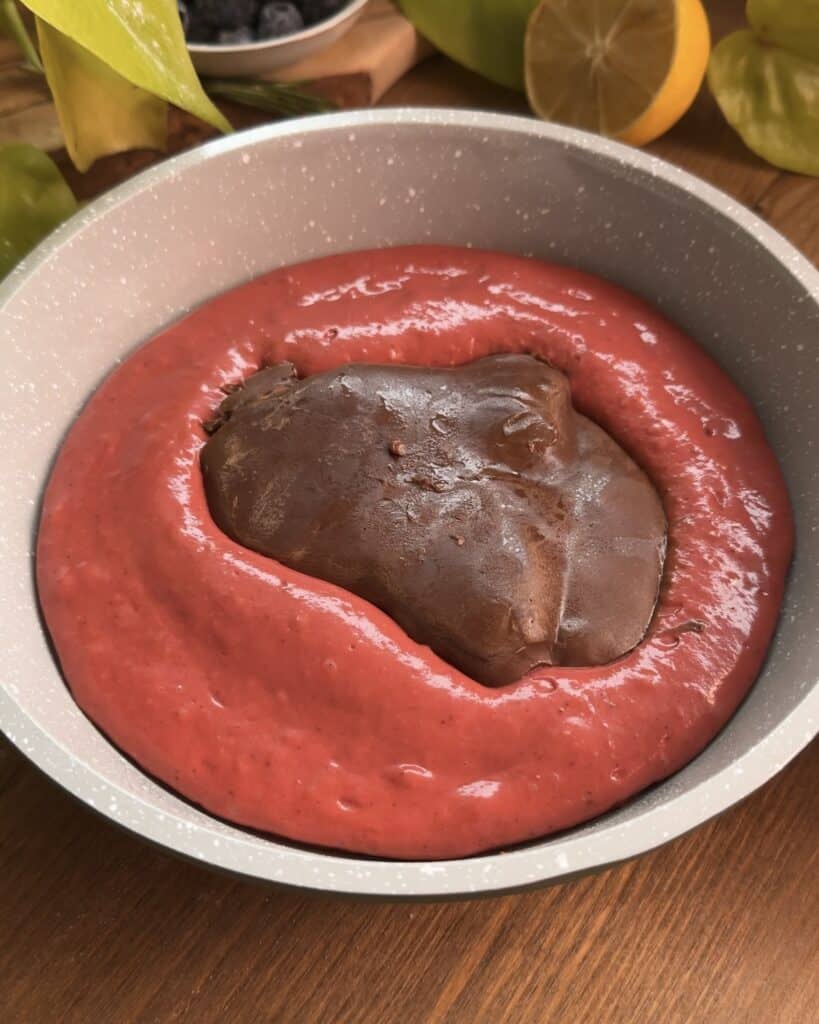 Adding a frozen Nutella disk in the center of the pancake batter and covering it with more batter to make decadent Red Velvet Nutella Pancakes