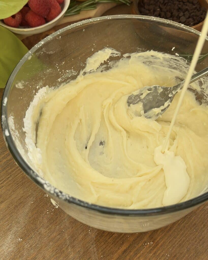 Adding heavy cream to the mascarpone mixture to prepare a rich and velvety filling for tiramisu-inspired cookies