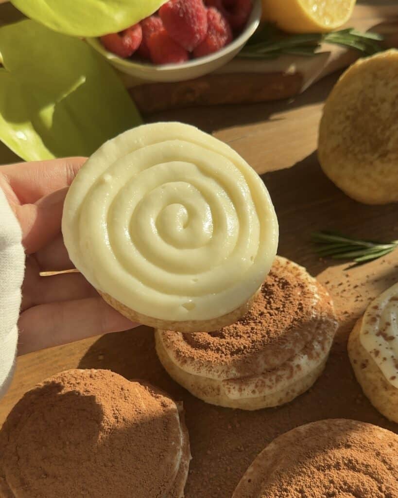 A beautifully piped cookie topped with a creamy mascarpone mixture, ready to be served as a decadent tiramisu cookie