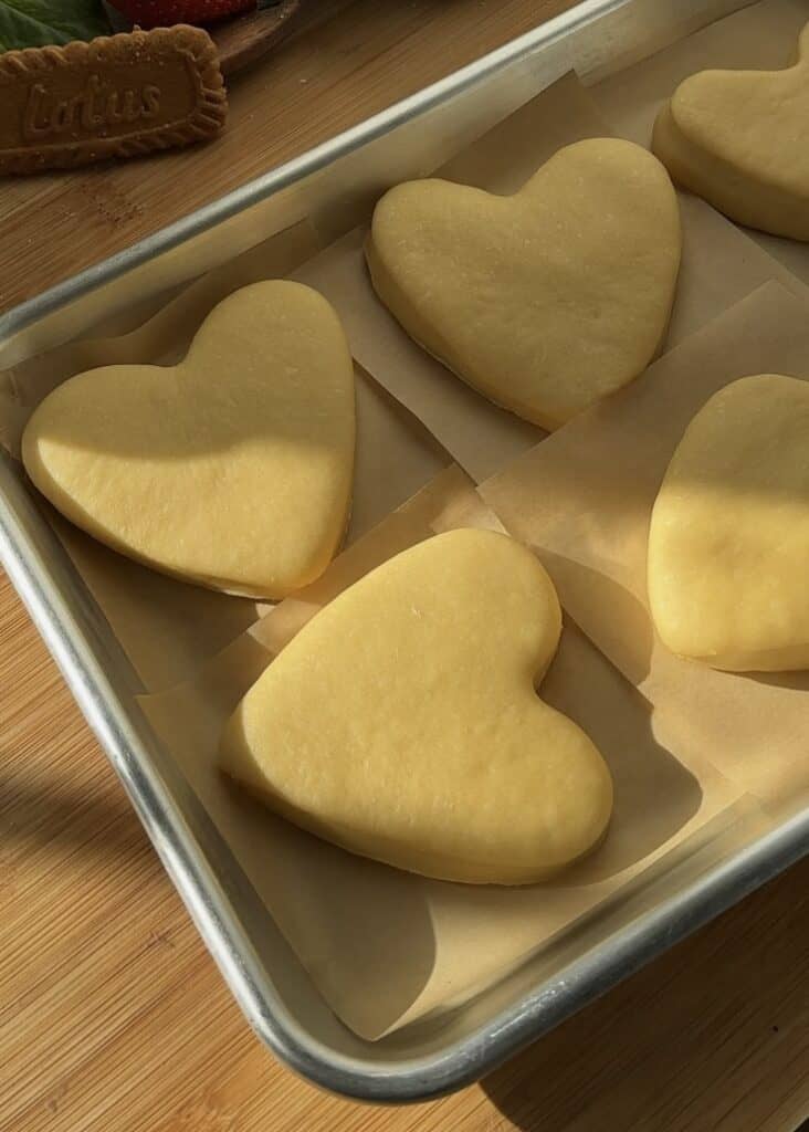 Proofed heart-shaped Nutella donuts ready to fry for Valentine’s Day treats.