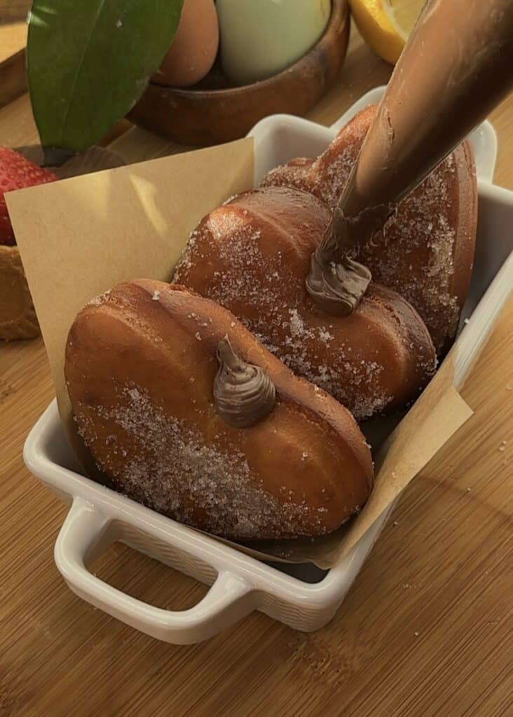 Nutella heart donuts coated with cinnamon sugar, perfect for Valentine’s Day.