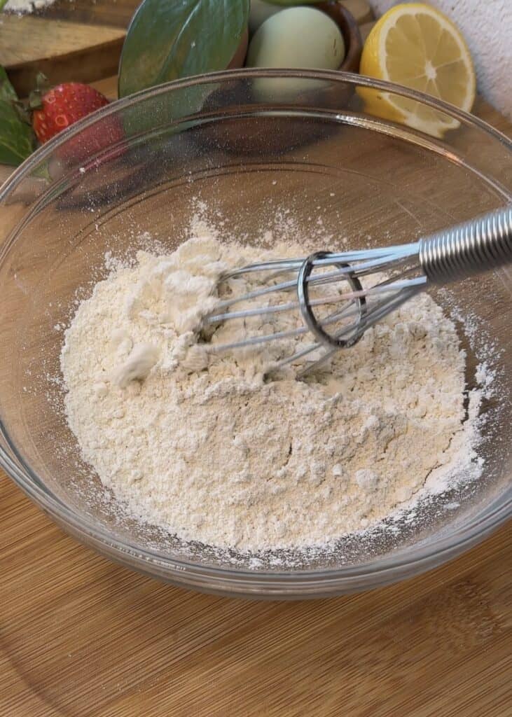 A bowl of sugar and flour for making crepe batter used in Nutella crepe rolls