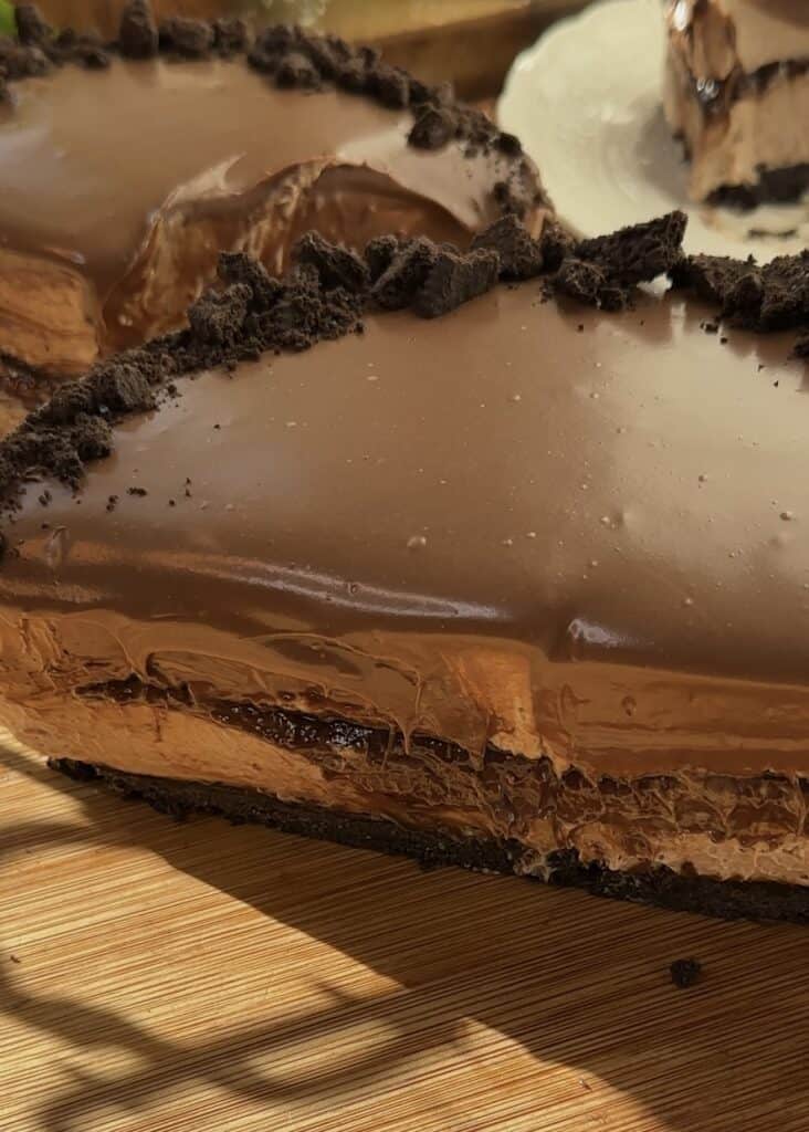 Layers of no-bake Nutella cheesecake with Oreo crust and Nutella center.
