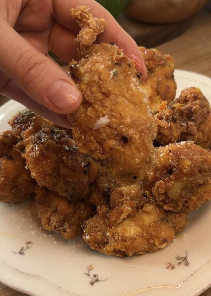 A golden-brown, crispy, and juicy chicken flat coated in a rich garlic Parmesan butter sauce.