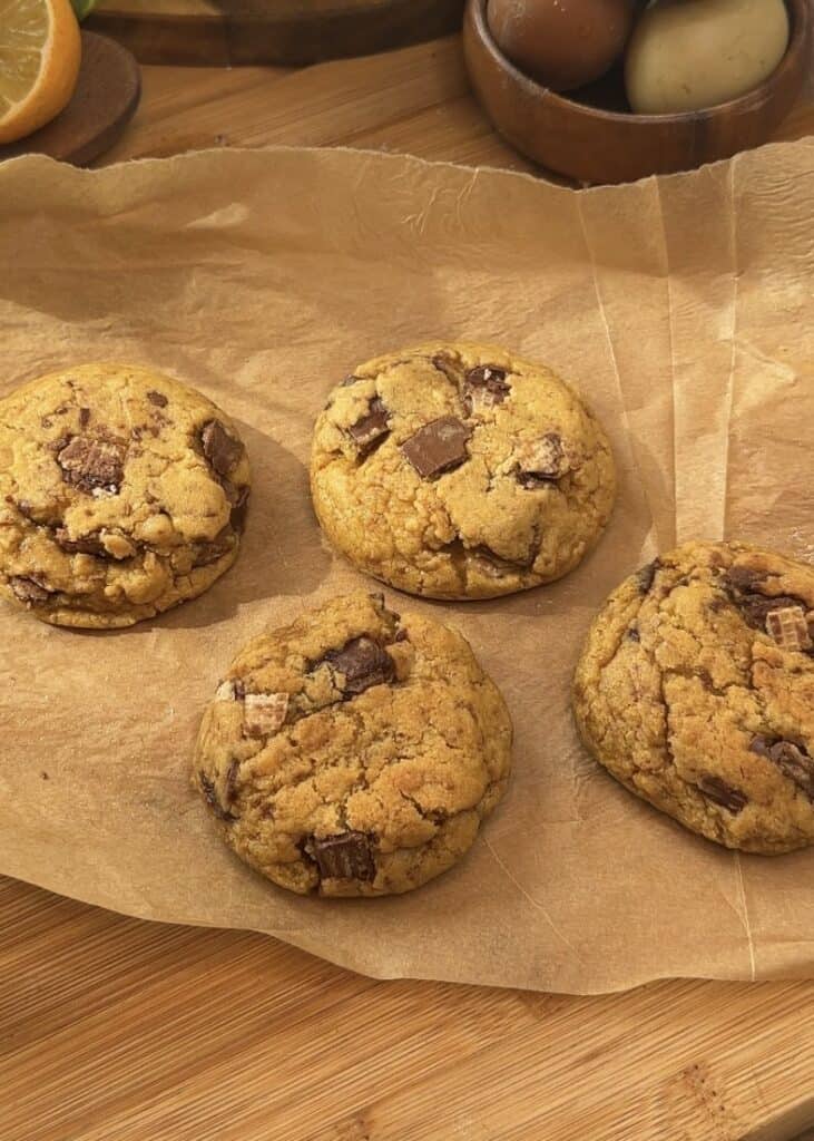 Freshly baked Copycat Crumbl KitKat cookies with a soft, gooey texture and melted KitKat pieces inside, just out of the oven.